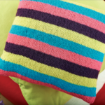 Multi-coloured striped flower cushion Knitting Pattern